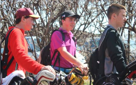 Freshmen+Drew+and+Colin+OHern+and+sophomore+John+Boosalis+head+off+to+their+golf+practice+on+April+21.+