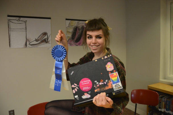 Sophomore Isabelle Saul-Hughes gets involved in safe-sex education by working at Planned Parenthood locations. “I think that sex ed is super important because it’s really easy to not know what is going on,” she said.  Here, she holds the ribbon she received for working with the Affordable Care Act:  “I was a member of the ObamaCare outreach team so I called people and told them about ObamaCare,” Saul-Hughes said. “With them I also went to see Obama [at the Union Depot on Feb. 26] , which was so cool.”