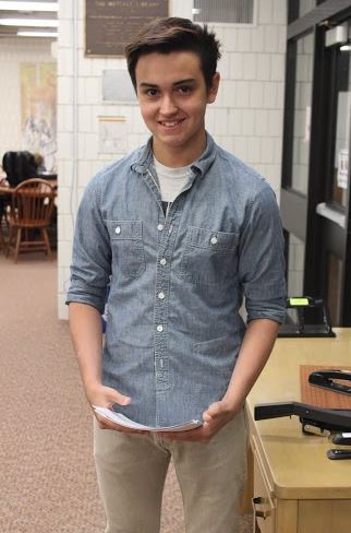 Senior Zach Zanaska wears a denim button up with khaki pants on a rainy April morning. 