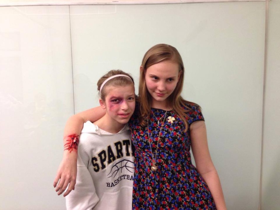 Sophomore Maren Findlay arranged a visit from make-up artist Mary K. Flaa to school as part of the ambassador program at Parl Square Theatre. Sophomore Calla Saunders and Findlay  pose with their fake injuries after the stage makeup  workshop.