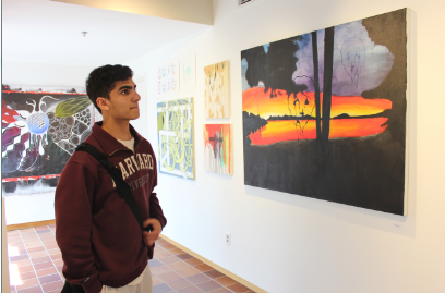 Freshman Muneil Rizvi observes a seniors painting in the Drake Gallery. 