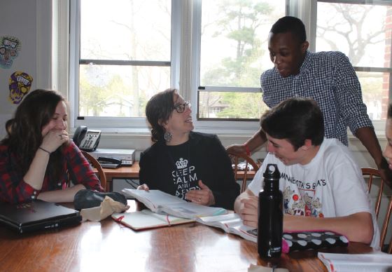 Upper School history teacher Weisgram works with her United States history students during a class. “ Working with students every day is by far my favorite part of teaching,” Weisgram said. 