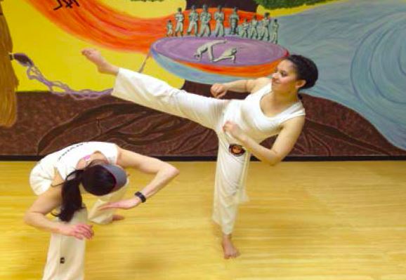 Junior Sandhya Ramachandran practices Capoeira, an Afro-Brazilian  form of martial arts and dance, at the Omulu Capoeira Academy of Minnesota. Ramachandran describes the club as very much like a family.