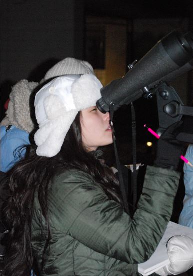 Senior Cynthia Zheng observes the blood moon during the Space Science class's star party. "There's a difference between classroom learning and experiential learning," senior Bilal Askari, a member of the Space Science class, said. "It was really very enjoyable and educational."