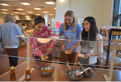 Sophomores neeti kulkarni, Katie Brunell, and Stephanie Li use sun butter, a substitute for peanut butter under the new nut-safe policy, to make sandwhiches at lunch. “I’m really sad but I understand as to why because it’s life threatening,” Li said.