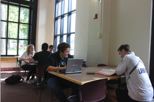 Upperclassmen work in the lunch room during Tutorial, now with laptops since the new WiFi was installed. “It’s nice because it is a quiet space and I get to work on group projects and get it done with wifi,” senior Nancy Moyers (pictured above left) said.