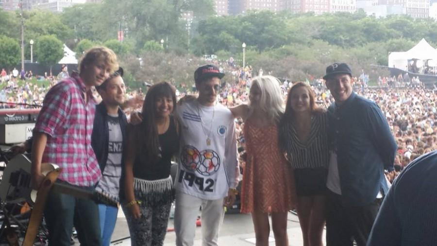 On stage at Lollapalloza, sophomore Emily Schoonover (third from right) poses with members of the band Portugal. The Man and other artists that she had met on tour.