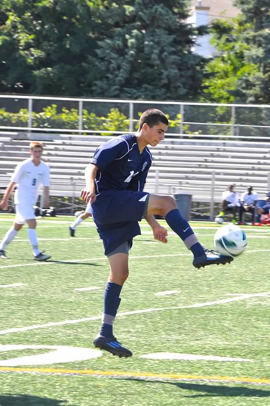 Freshman Eli Goldman powers through a Boys Varsity soccer game, jumping up to kick the ball back in for his team. "Eli is very driven...towards our team goal of winning and also towards playing his best," senior Dean Isaacson said.