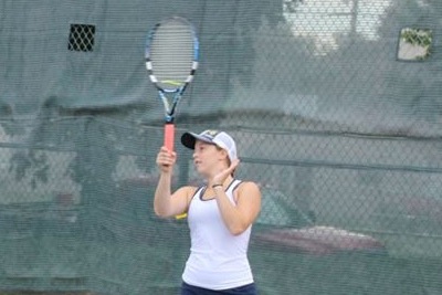 Junior tennis player Ella Hommeyer prepares to return the ball during practice. "I know I’m lucky to still be playing because most tennis players are done at this point in the season so I’ll try to make the most of this opportunity,” Hommeyer said. 