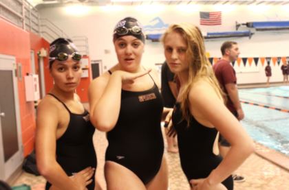 Swimmers, sophomore Kathryn Schmechel, junior Cait Gibbons, and captain, senior Katiana Taubenberger strike a pose. “When in doubt, whoo it out,” Taubenberger said.