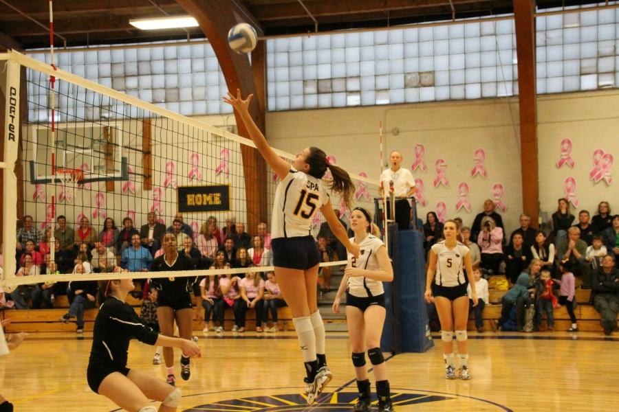 Senior Mira Grinsfelder sets the ball for a spike across the net in the Dig Pink game against DeLaSalle Oct. 10.