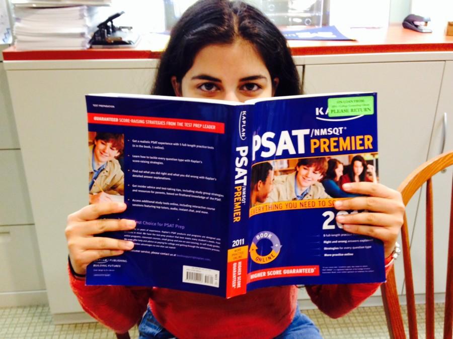 Senior+national+merit+semifinalist+Neerja+Thakkar+browses+through+a+test+prep+book