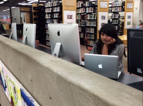 Sophomore Tabeer Naqvi explores the programs available on the iMacs in the Upper library. “[you can use them] when you have those projects where you have to put in pictures or make videos...compared to the computers we have now, there’s so much more we can do on them,” she said. 