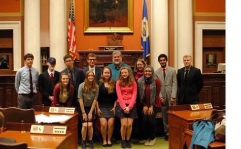 Debaters line up for a picture at the state capitol. “It was a little tricky to understand the voices echoing through the mic but we pulled it off. The setting made things a little more formal, but we all make the choice to go out and dress in suits so we have fun with that stuff,” Wheaton said.