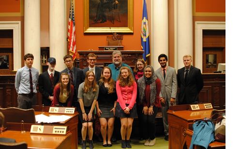 Debaters line up for a picture at the state capitol. “It was a little tricky to understand the voices echoing through the mic but we pulled it off.  The setting made things a little more formal, but we all make the choice to go out and dress in suits so we have fun with that stuff,” Wheaton said.