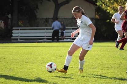 Sophomore Lauren Hansen dribbles down the field in a game against Richfield on Oct 7. St. Paul Academy and Summit School won 7-0. “I am grateful for my team and the great season,” Hansen said.