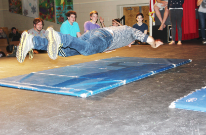 PHYSICAL COMEDY COACH STEVE EPP demonstrates how to do a controlled, comedic fall.  “[Epp is] doing a series of exercises with the cast, thinking about isolating different parts of their bodies…[teaching them] how to be completely in control of [their] bodies while making it look like they’re not in control,” US Theater Director Eric Severson said.