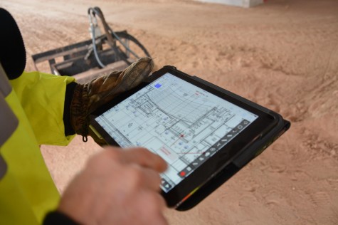 Mahanna points out the hallway of the Huss Center on his iPad. "Everything is on here...with the iPad..questions always get answered within a reasonable amount of time," construction superintendent Tim Mahanna said.