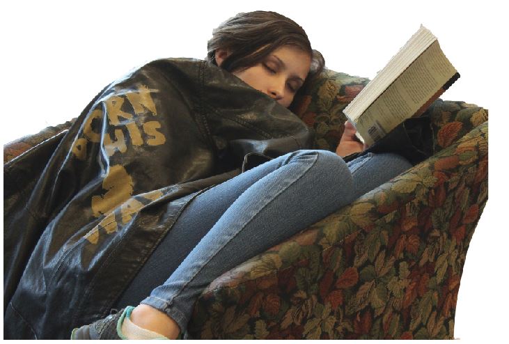 Senior Dani Tiedemann pretends to catch a quick nap in the Summit Center between classes.   Students who suffer from lack of sleep may struggle to stay awake at school and have difficulty paying attention in class, according to the National Sleep Foundation.