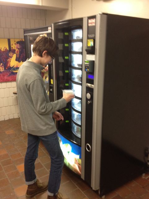 Sophomore Andrew Michel checks out the new vending machines in the athletic hallway.