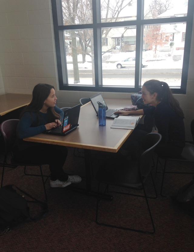 Sophomores Maria Perkkio and Genevieve Zanaska work in the lunch room during their free period. “It’s nice to be able to work [in the lunch room] because sometimes the benches get really loud,” Perkkio said.