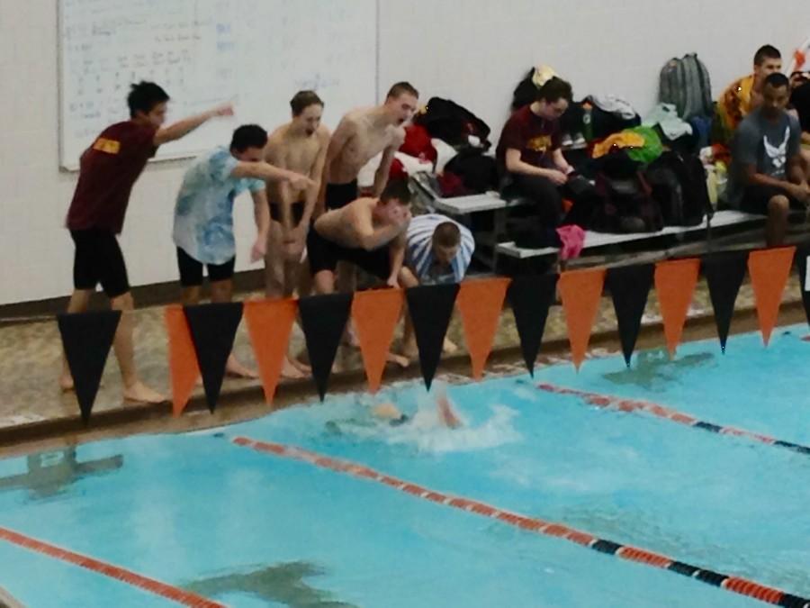The+boys+varsity+swim+team+cheers+on+their+teammate+during+the+300m+breast-fly+relay.