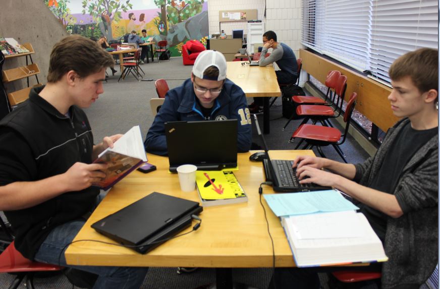 Juniors Charlie Ward, Sam Tipler, and Joel Tibbetts study for finals in the Lower Library. It is better to start studying  early in the week rather than just waiting until the weekend, Tibbetts said. 