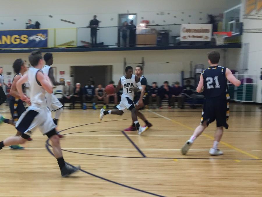 Junior Dalante Peyton makes a run for the basket against Breck. "[The zone defense] really confused us and we lost our composure a little and they created turnovers," senior Sam Suzuki said.