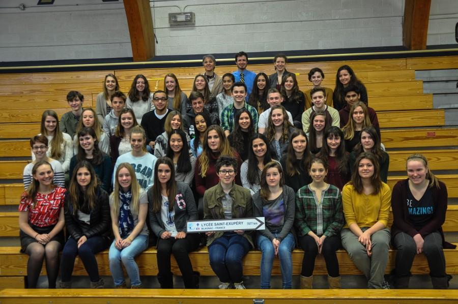 The French Exchange Students and their hosts smile for a group photo in the gym..