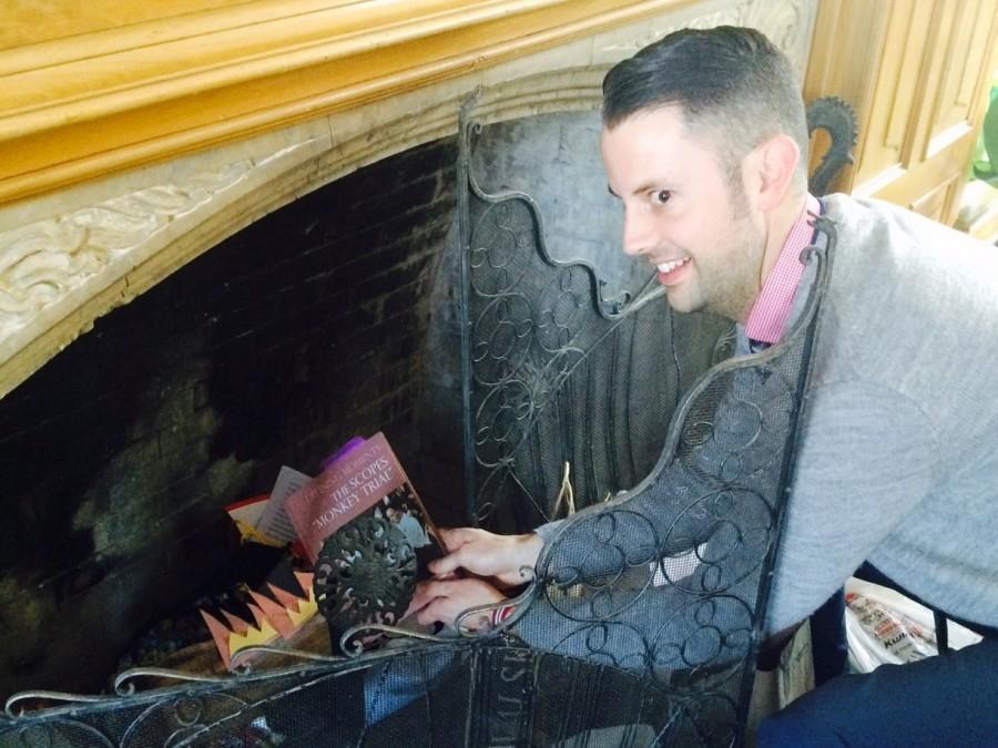 Upper School history teacher Aaron Shuler pretends to throw a book into the fireplace, something highly unusual of him. Something else that he doesn't usually do is hand out insider teacher hacks to students.