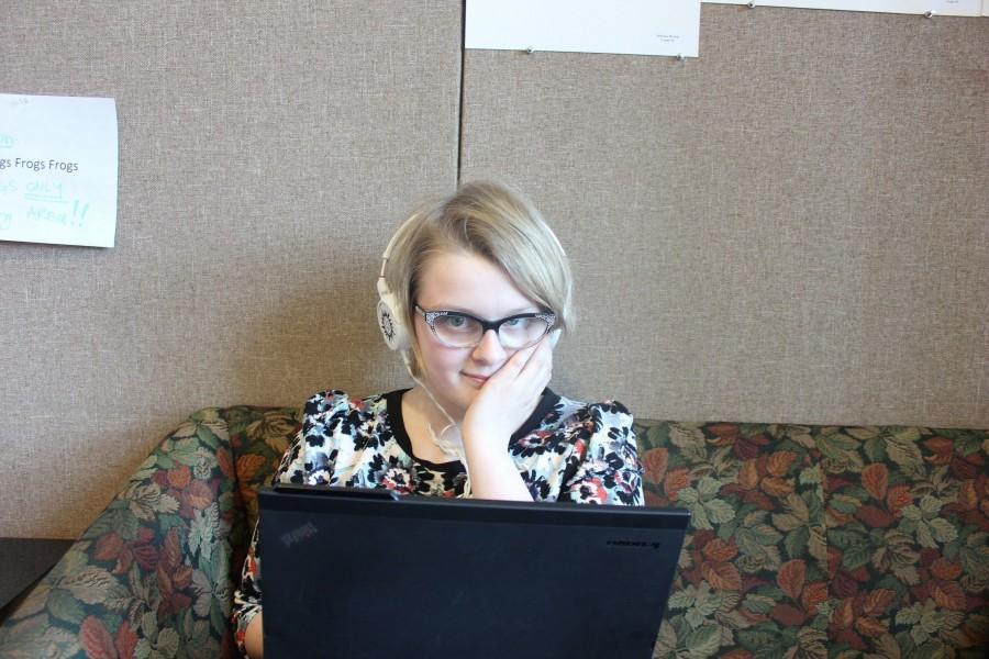 Sophomore Ellie Brass listens to music through headphones. "They [the songs] speak to me on a deep level," she said.