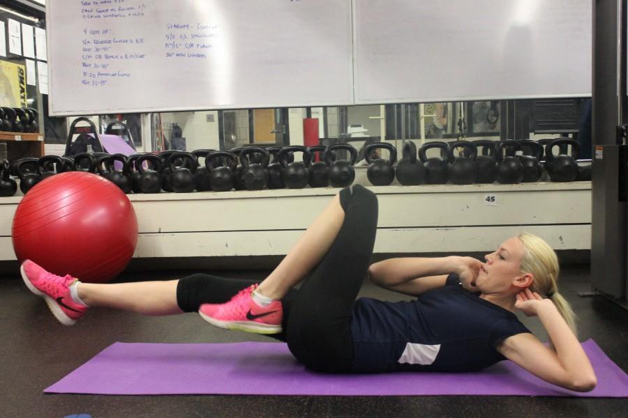 The alternating leg twist crunch works the abdominal, back and upper arm muscles. 