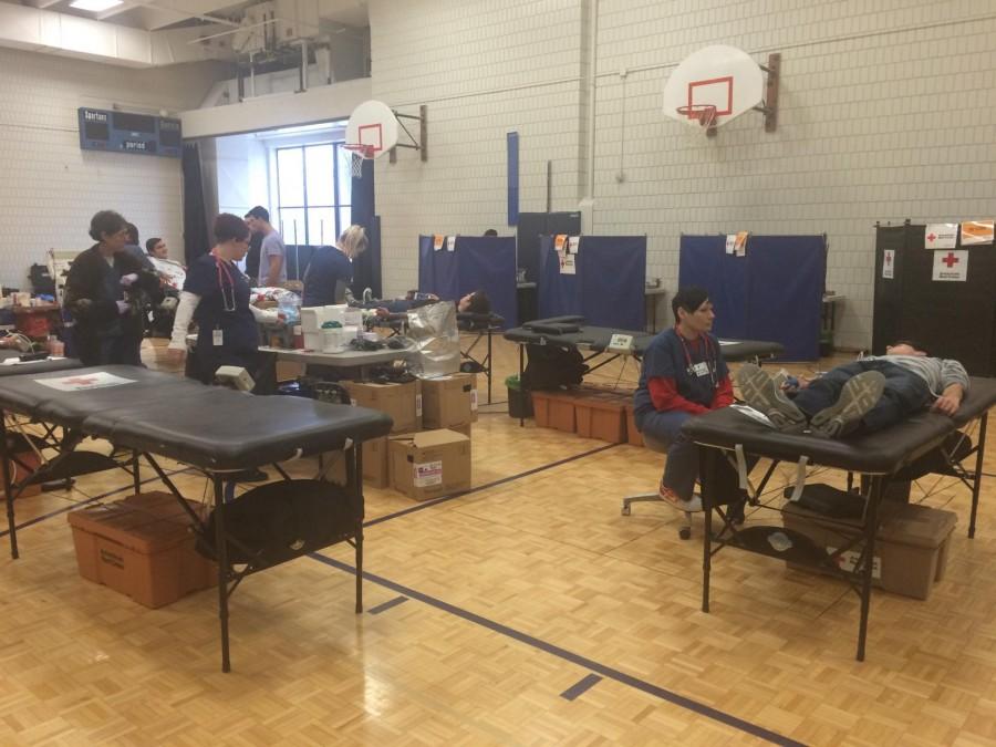 Red Cross workers collect blood donations in the small gym on Feb. 3. “It felt good, aside from a little wooziness. I’m happy I did it,” sophomore Joel Tibbetts said. The drive collected 31 units of blood.