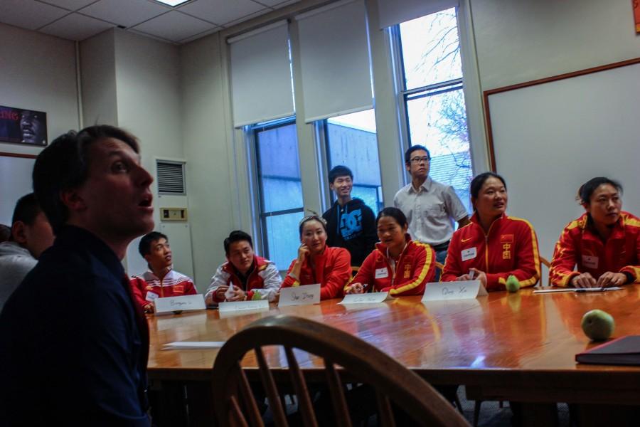 Chinese athletes have a discussion with St. Paul Academy and Summit School students around a Harkness Table. “The Chinese Athletes were really willing to answer the questions that we asked and they were interested in learning about our school too,” sophomore Soph Lundberg said.