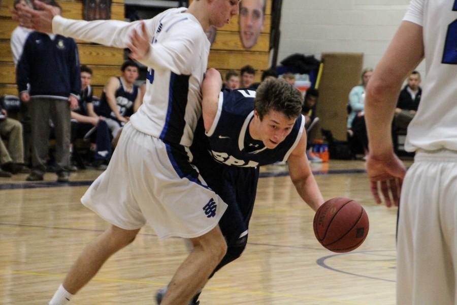 Junior Kent Hanson drives towards the net.