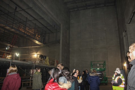 Students on the tour step on stage to listen to a short presentation from the Coordinators of Construction.