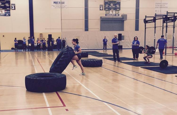 Sophomore Maria Perkkio works on flipping a tire to complete a workout during a CrossFit competition. Perkkio was ranked 18 in the nation for her age group for the CrossFit Open Workout 15.1. “It’s pretty challenging to really push yourself during competitions and it gets very competitive but everyone’s super supportive of each other,” Perkkio said.