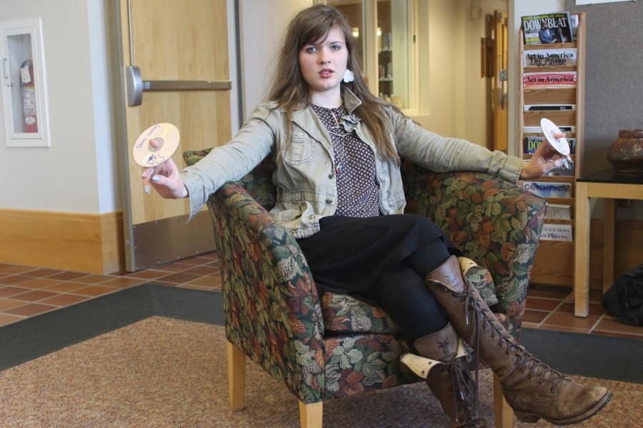 Junior Ingrid Topp-Johnson poses with some of her recent mixtapes. “When I am making a playlist, I usually come up with a very specific idea and then sit down at a computer and create it within half an hour,” Topp- Johnson said.