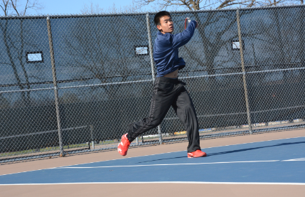 Senior Eliot Tong slams a ball across the net at a match against The Blake School on April 22. “ Blake is a very tough opponent, but it is fun to play them,” Tong said. The tennis team has an upcoming match on May 5, at home against Minnehaha Academy at 4 pm.