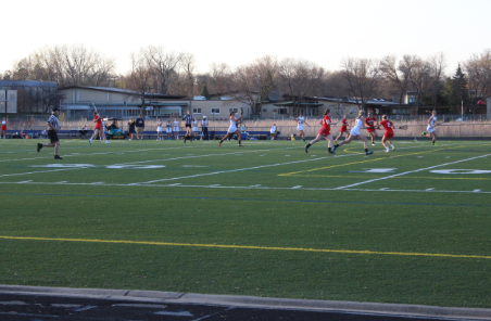 The United girls’ lacrosse team plays in a game against The Breck School on April 14. The team lost 9-21. “We have lots of fast runners that can move the ball quickly,” senior Sarah Romans said.