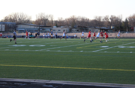 The United girls’ lacrosse team plays in a game against The Breck School on April 14. The team lost 9-21. “We have lots of fast runners that can move the ball quickly,” senior Sarah Romans said. 