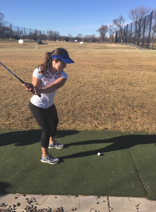 Sophomore Maria Perkkio practices with her irons at the Highland Driving Range on April 9. “Coach D has a great sense of humor  and she has really improved my swing,” Perkkio said.  