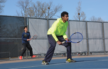 JUnior matti solomon (centered) plays in a doubles match here with senior Elliot Tong. Solomon participated in section play and was the only varsity member to make it to the second round