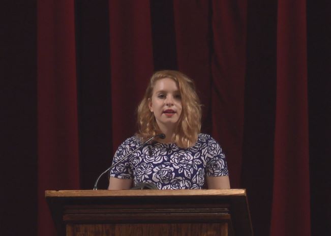 Bukingolts's speech revolved around the idea of victimization and self help. "We trap people in their tragedy, and maybe we’re starting to move past the whole blaming thing but we give power to those who have hurt them when we reduce them to the word ‘victim’ because in doing so, we take away their power to define themselves. But that horrible period in my life that labels me as a victim is not who I am. It does not define me. I am the girl who trips over air, is constantly shushed in the library, and who once screamed so loud in the lunchroom that everyone fell silent and just looked at me, the weird loud person," Bukingolt's said.
