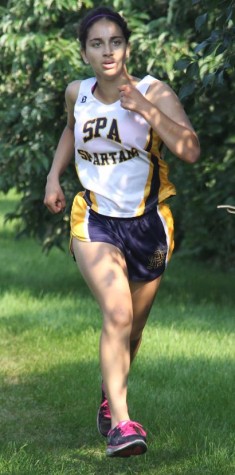 JUNIOR NEETI KULKARNI runs toward the end of a race at St. Kate’s. “The team’s goal for this season is to get closer,” sophomore Val Hart said.