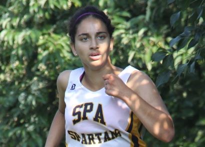 JUNIOR NEETI KULKARNI runs toward the end of a race at St. Kate’s. “The team’s goal for this season is to get closer,” sophomore Val Hart said.