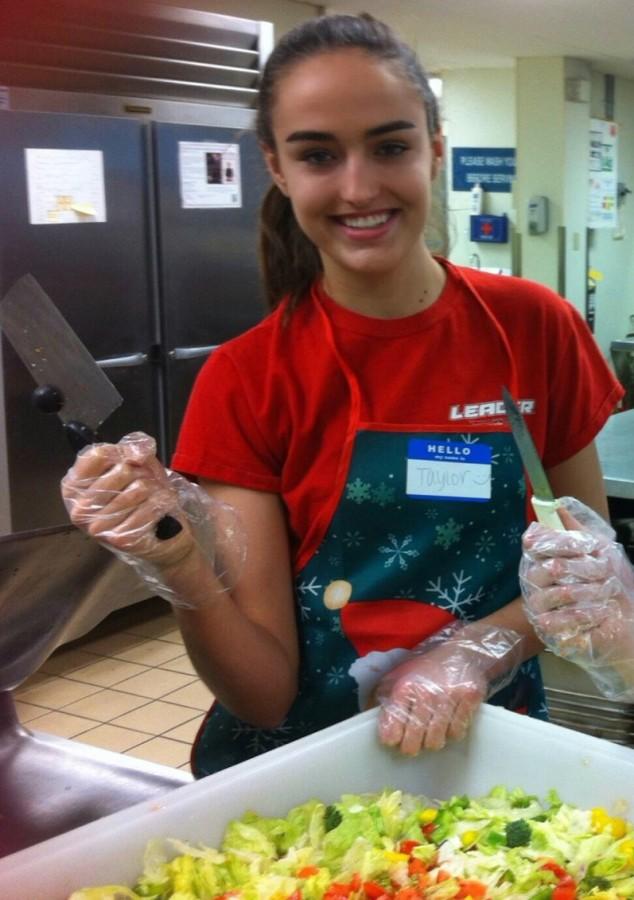 Senior Taylor Rients prepares food at Sharing and Caring Hands during the holiday season. "Seeing and helping these people has been a big eye opener for me," Rients said.
