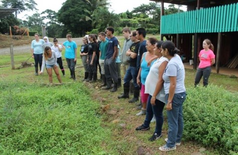 The group prepares to pull weeds from a ginger garden for a womens' group as a form of community service. 