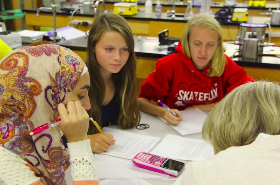 Sophomores Iya Abdulkarim, Emily Carter and Emma Hills work on problems in Honors Chemistry. 