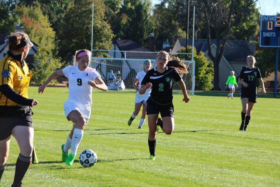 Sophomore Hayley Hoffmann makes a run down the sideline in the middle of the first half. It was awesome to have the crowd there at the beginning of the game, I know that I was so excited before the game started and everyone else was too, Hoffmann said. (Photo credit: Stephanie Li) 